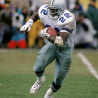 SAN FRANCISCO - JANUARY 17:  Running back Emmitt Smith #22 of the Dallas Cowboys hustles for yards during the 1992 NFC Conference Championship game against the San Francisco 49ers at Candlestick Park on January 17, 1993 in San Francisco, California.  The Cowboys won 30-20.  (Photo by George Rose/Getty Images) *** Local Caption *** Emmitt Smith